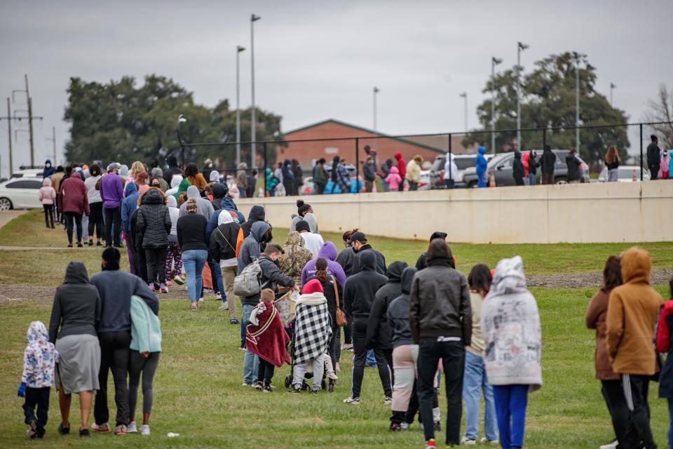 Hundreds of people wait in line to be tested for COVID-19 at the Florida A&M University testing site Monday, Jan. 3, 2022.