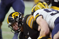 Iowa quarterback Spencer Petras, left, is sacked by Michigan defensive end Aidan Hutchinson, right, during the first half of the Big Ten championship NCAA college football game, Saturday, Dec. 4, 2021, in Indianapolis. (AP Photo/Darron Cummings)