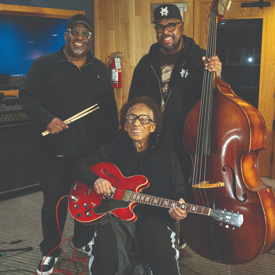 George Freeman (seated) in the studio with his bandmates, May 2022