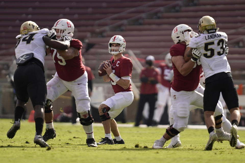 Stanford quarterback Davis Mills, center, looks to pass against Colorado during the first half of an NCAA college football game in Stanford, Calif., Saturday, Nov. 14, 2020. (AP Photo/Jeff Chiu)