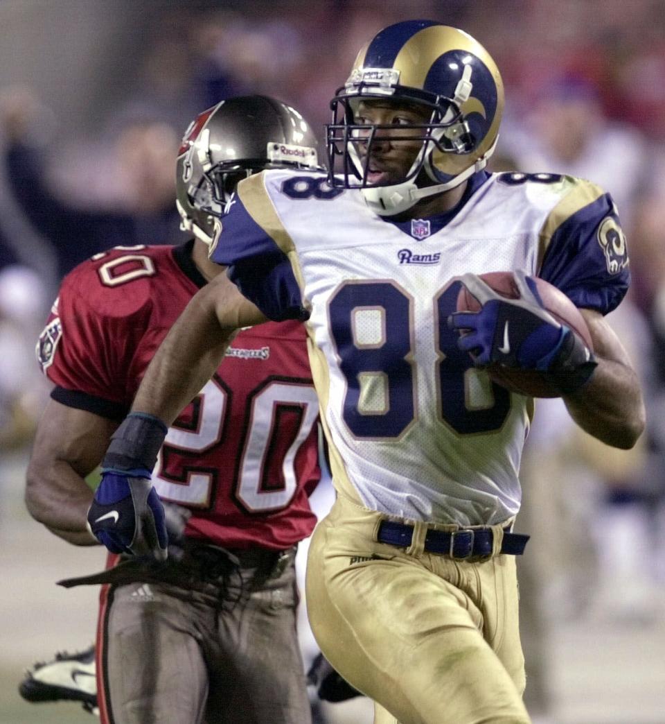 FILE - In this Dec. 18, 2000, file photo, St. Louis Rams wide receiver Torry Holt outruns Tampa Bay Buccaneers cornerback Ronde Barber (20) on a 73-yard touchdown reception during the fourth quarter of an NFL football game at Raymond James Stadium in Tampa, Fla. Holt was selected as a finalist for the Pro Football Hall of Fame's class of 2021 on Tuesday, Jan. 5, 2021.(AP Photo/Chris O'Meara, File)