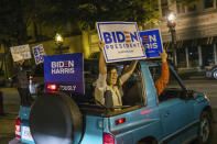 Supporters of President-elect Joe Biden and Vice President-elect Kamala Harris celebrate in Decatur, Ga., Saturday night, Nov. 7, 2020. (Jenni Girtman/Atlanta Journal-Constitution via AP)