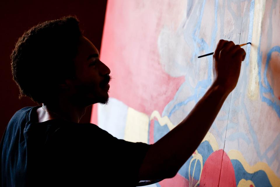 Huey Robinson paints his piece “Look both ways before you cross my mind” on March 4 for the Fresh Paint mural project in Oklahoma City.