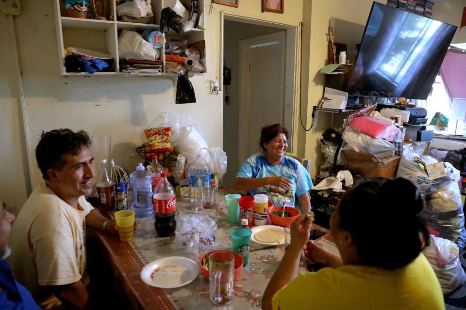 People gathered in a one-bedroom apartment in the Pico-Union neighborhood of Los Angeles.