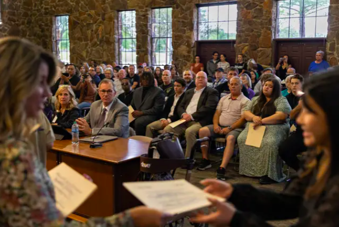 Students accept awards in arts and academics at a Keller ISD school board meeting. School board meetings across the state have seen high attendance, becoming political battlegrounds for a variety of social issues. (Shelby Tauber / The Texas Tribune)