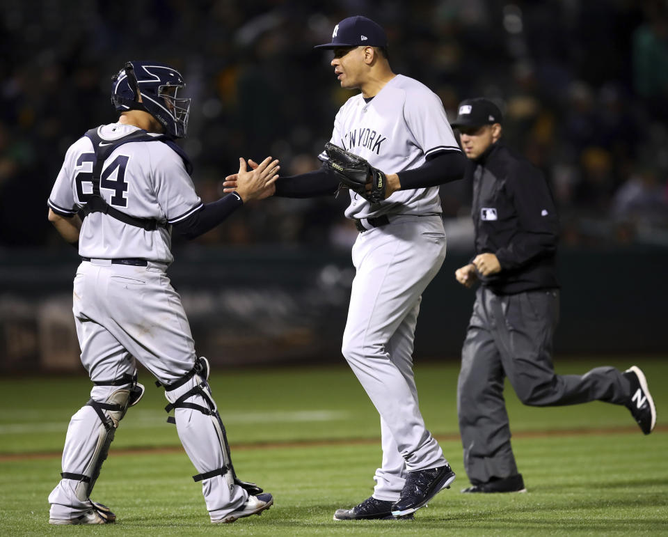 New York Yankees pitcher Dellin Betances, right, celebrates the team's 5-1 win over the Oakland Athletics with Gary Sanchez (24) at the end of athebaseball game Tuesday, Sept. 4, 2018, in Oakland, Calif. (AP Photo/Ben Margot)