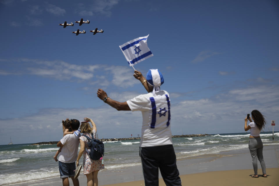 Israelis watch an air show during Israel's 71st Independence Day celebrations in Tel Aviv, Israel, Thursday, May 9, 2019. Israel is celebrating its annual Independence Day, marking 71 years since the founding of the state in 1948. (AP Photo/Oded Balilty)