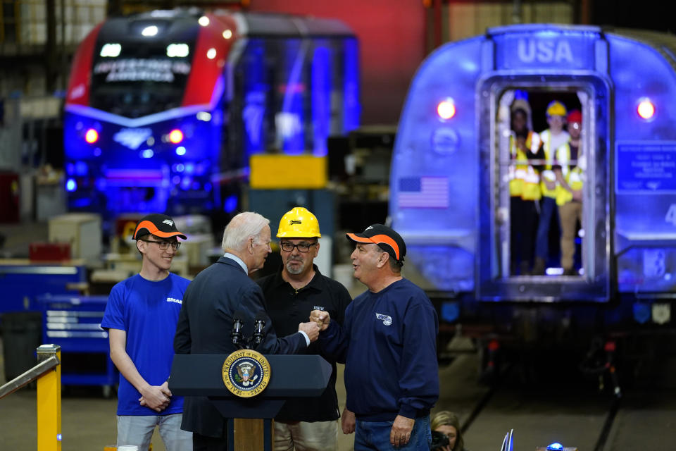 President Joe Biden, center left, meets with Thomas Rapposelli Jr., left, Sterling Rapposelli Jr., center right, and Tom Rapposelli who introduced him before speaking at the Amtrak Bear Maintenance Facility, Monday, Nov. 6, 2023, in Bear, Del. (AP Photo/Matt Rourke)