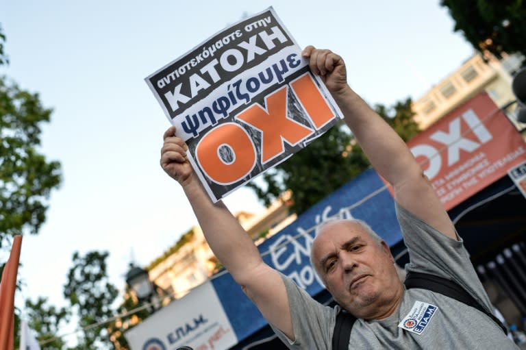 A man holds a sign which reads "No" for the vote in the Greek referendum, as he celebrates at Syntagma Square in Athens on July 5, 2015