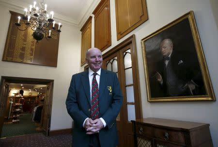 Former club captain Michael Fleming poses by a portrait of Winston Churchill inside the clubhouse of the Wentworth Club in Virginia Water, Britain, January 8, 2016. REUTERS/Peter Nicholls