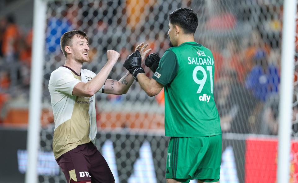 Detroit City FC defender Stephen Carroll (5) and goalkeeper Carlos Saldana (91) react after a penalty kick against Houston Dynamo FC at Shell Energy Stadium in Houston on Tuesday, May 7, 2024.