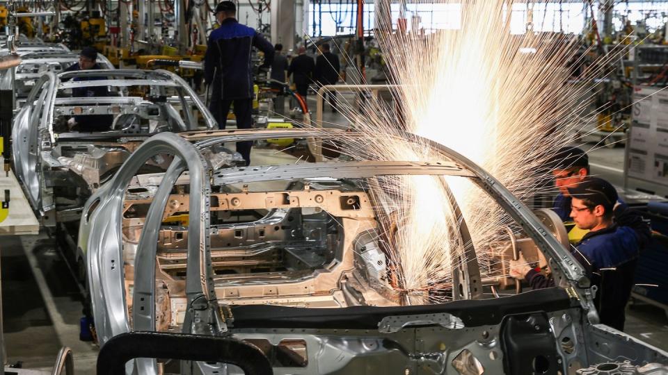 An einer Karosserie schweißen Arbeiter im Karosseriebau des Mercedes-Benz-Werks im Industriepark Yesipovo bei Moskau.