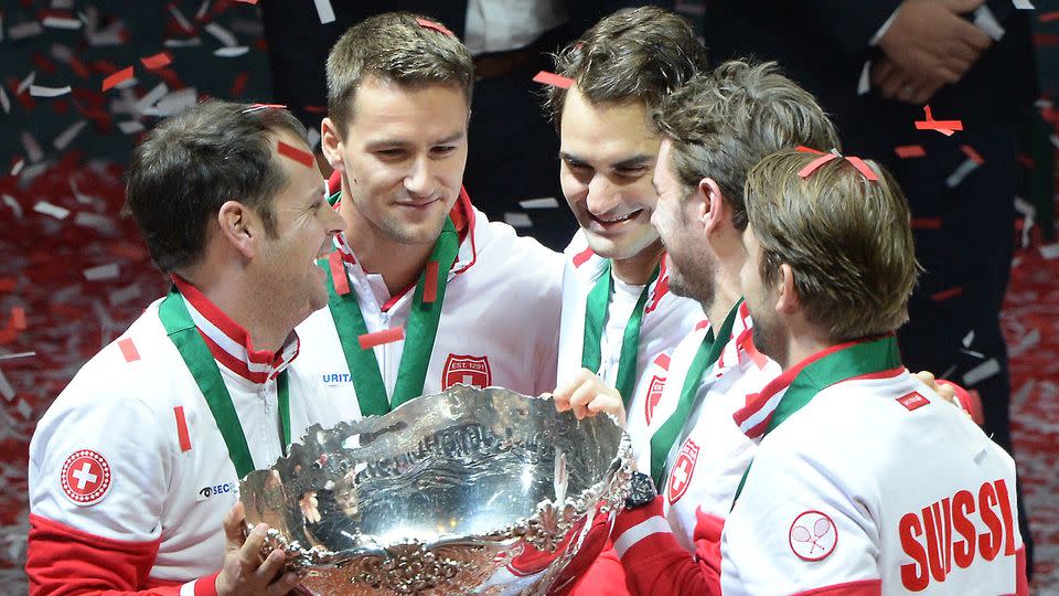 Chiudinelli and Federer (middle) celebrate the Davis Cup triumph. Pic: Getty