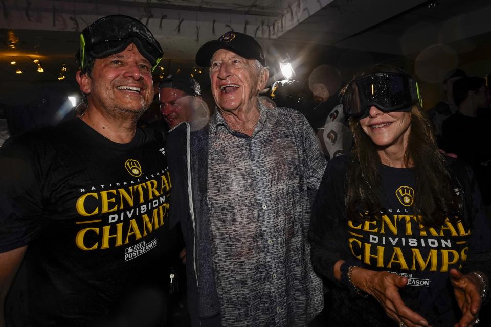 Milwaukee Brewers' owner Mark Attanasio and wife Debbie celebrate with broadcaster Bob Uecker after clinching the National League Central Division after a baseball game against the St. Louis Cardinals Tuesday, Sept. 26, 2023, in Milwaukee. (AP Photo/Morry Gash)