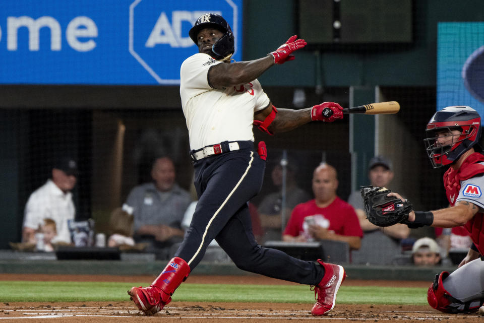 Texas Rangers' Adolis Garcia (53) swings at a pitch in the bottom of the first inning in a baseball game against the Cleveland Guardians in Arlington, Texas, Saturday, July 15, 2023. (AP Photo/Emil T. Lippe)