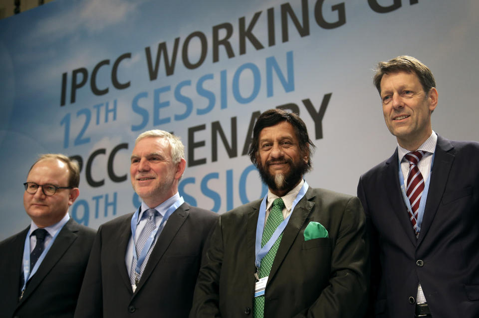 FILE - In this Monday, April 7, 2014 file photo Ottmar Edenhofer, Co-Chairman of the IPCC Working Group III, Jochen Flasbarth, State Secretary of the German Enviroment Ministry, Rejendra K. Pachauri, Chairman of the IPCC, and Jochen Schuette, State Secretary of the German Science Ministry, from left, pose for the media prior to a meeting of the Intergovernmental Panel on Climate Change, IPCC, in Berlin, Germany. After racing against the clock in an all-night session, the U.N.'s expert panel on climate change was putting the final touches Saturday, April 12, 2014, on a scientific guide to help governments, industries and regular people take action to stop global warming from reaching dangerous levels. (AP Photo/Michael Sohn, File)