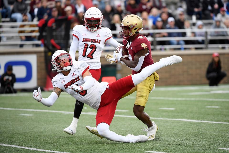 Oct 1, 2022; Chestnut Hill, Massachusetts, USA;  Boston College Eagles wide receiver Zay Flowers (4) catches the ball for a touchdown past Louisville Cardinals defensive back Josh Minkins (5) and cornerback Jarvis Brownlee (12) during the first half at Alumni Stadium. Mandatory Credit: Bob DeChiara-USA TODAY Sports