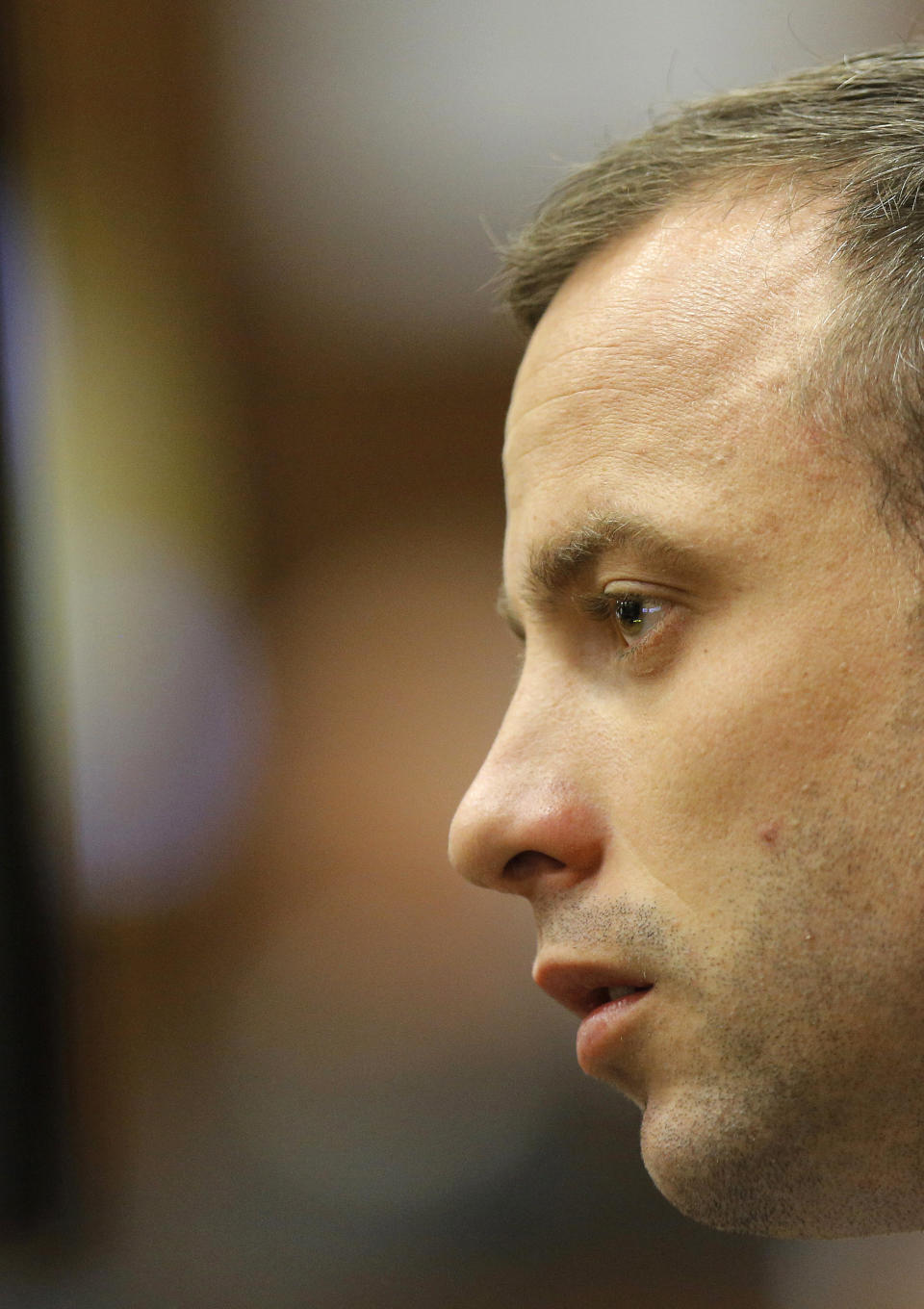 Oscar Pistorius appears in the dock on the second day of his trial at the high court in Pretoria, South Africa, Tuesday, March 4, 2014. Pistorius is charged with murder for the shooting death of his girlfriend, Reeva Steenkamp, on Valentine's Day in 2013. (AP Photo/Kim Ludbrook, Pool)