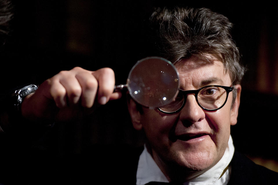 LONDON, ENGLAND - MAY 14:  Comedian Joe Pasquale inspects Robert Downey Junior's Sherlock Holmes wax figure at Madame Tussauds on May 14, 2013 in London, England.  Pasquale is set to play Sherlock Holmes later this year. (Photo by Ben A. Pruchnie/Getty Images)