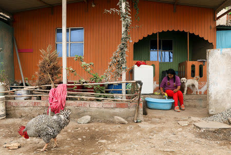 Leydi Condor washes her clothes outside her home in Nueva Union shantytown in Villa Maria del Triunfo district of Lima, Peru, May 25, 2018. REUTERS/Mariana Bazo