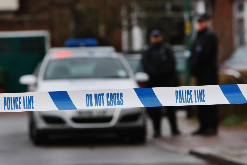 Police tape is pictured as police officers stand guard outside of a house in Edgeware on December 27, 2007 in London, England. A plastic surgeon is facing attempted murder charges in a stabbing incident. (Getty Images)