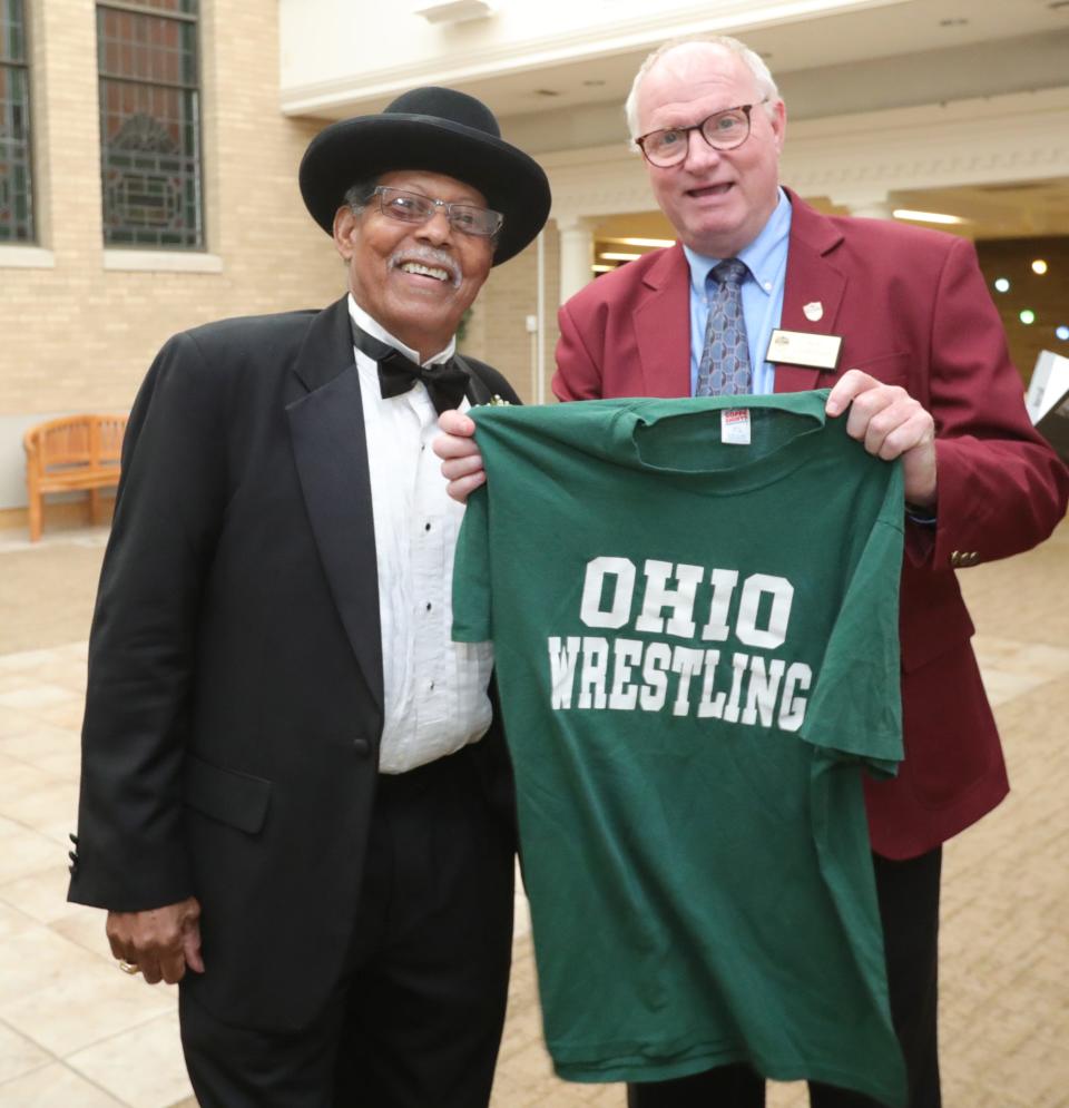 Summit County Sports Hall of Fame inductee Andy Daniels stops for a photo with his Ohio Bobcats wrestling team trainer Rob Culberson before the banquet Tuesday at Annunciation Greek Orthodox Church in Akron.
