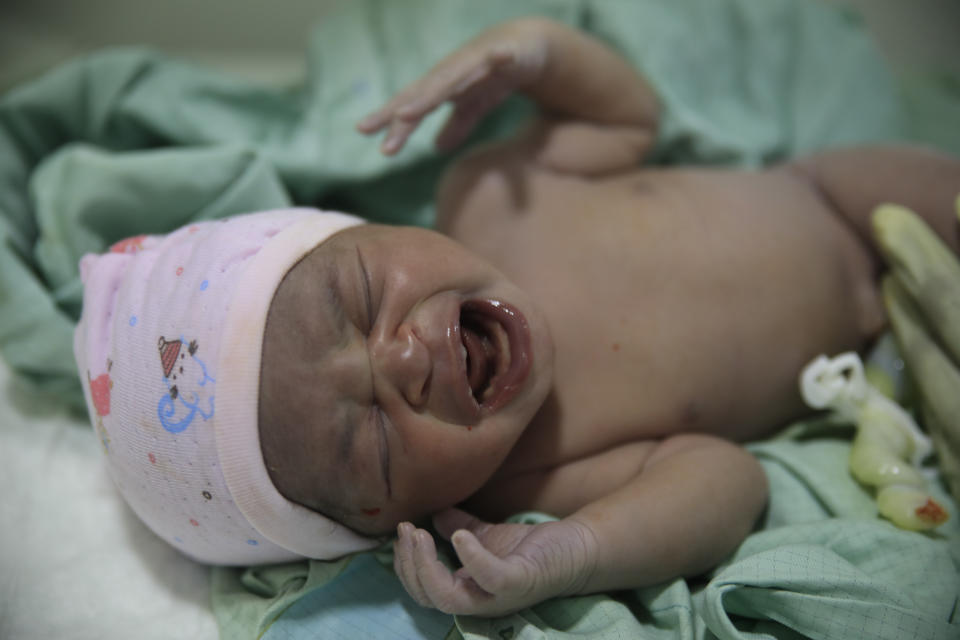 A newborn baby cries after a caesarean operation by maternity workers at the Fontaine Hospital Center in the Cité Soleil area of Port-au-Prince, Haiti, Monday, Jan. 23, 2023. As gangs tighten their grip on Haiti, many medical facilities in the Caribbean nation's most violent areas have closed, leaving Fontaine as one of the last hospitals and social institutions in one of the world's most lawless places. (AP Photo/Odelyn Joseph)