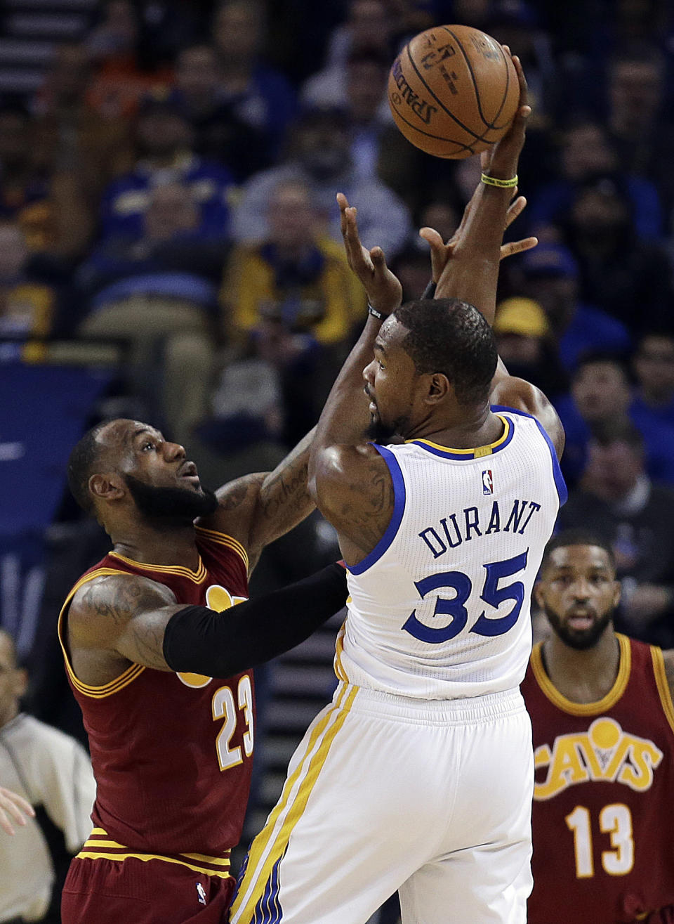 Golden State Warriors' Kevin Durant (35) looks to pass away from Cleveland Cavaliers' LeBron James (23) during the first half of an NBA basketball game Monday, Jan. 16, 2017, in Oakland, Calif. (AP Photo/Ben Margot)