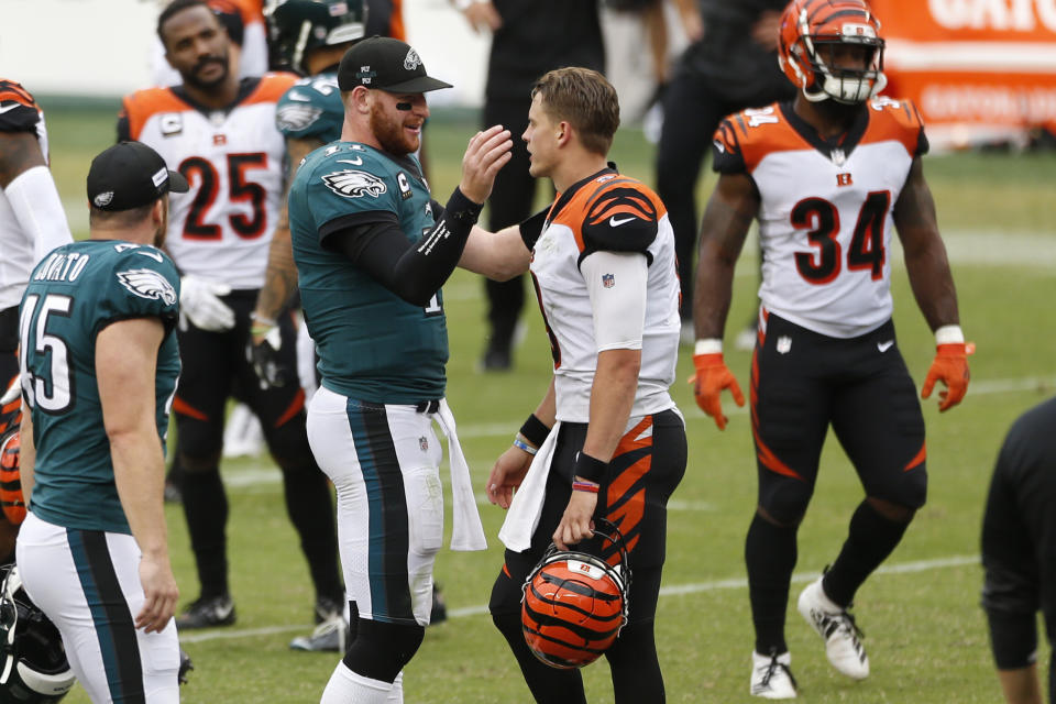 Philadelphia Eagles' Carson Wentz, left, and Cincinnati Bengals' Joe Burrow meet after an NFL football game, Sunday, Sept. 27, 2020, in Philadelphia. (AP Photo/Laurence Kesterson)