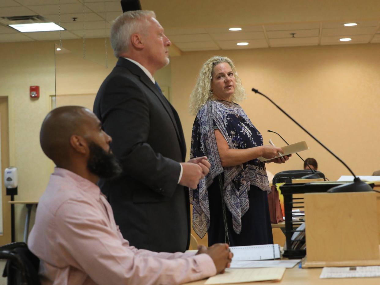 Special District Attorney Julia Cornachio speaks while in the Town of Wallkill in Middletown on August 23, 2023. Edward Holley and his attorney Paul Weber are in the foreground. 