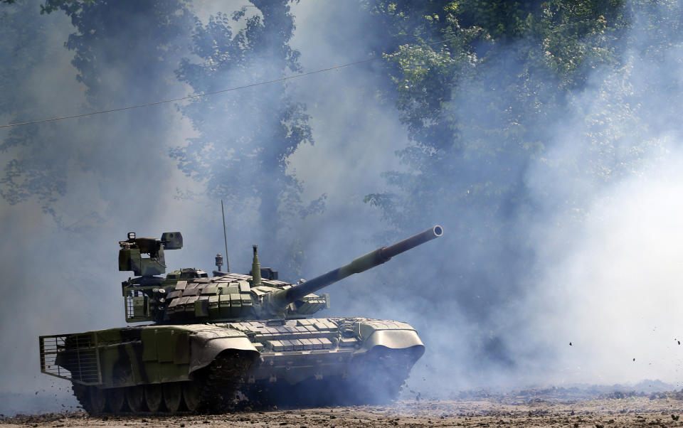 FILE - In this Tuesday, May 9, 2017 file photo, a Serbian army tank performs during exercise at a ceremony marking 72 years since the end of WWII and the defeat of Nazi Germany, at Nikinci training ground, 60 kilometers west of Belgrade, Serbia. Serbia will continue to strengthen its armed forces and is ready to purchase more warplanes amid simmering tensions in the Balkans, the Serbian president said Sunday, July 26, 2020. (AP Photo/Darko Vojinovic, file)