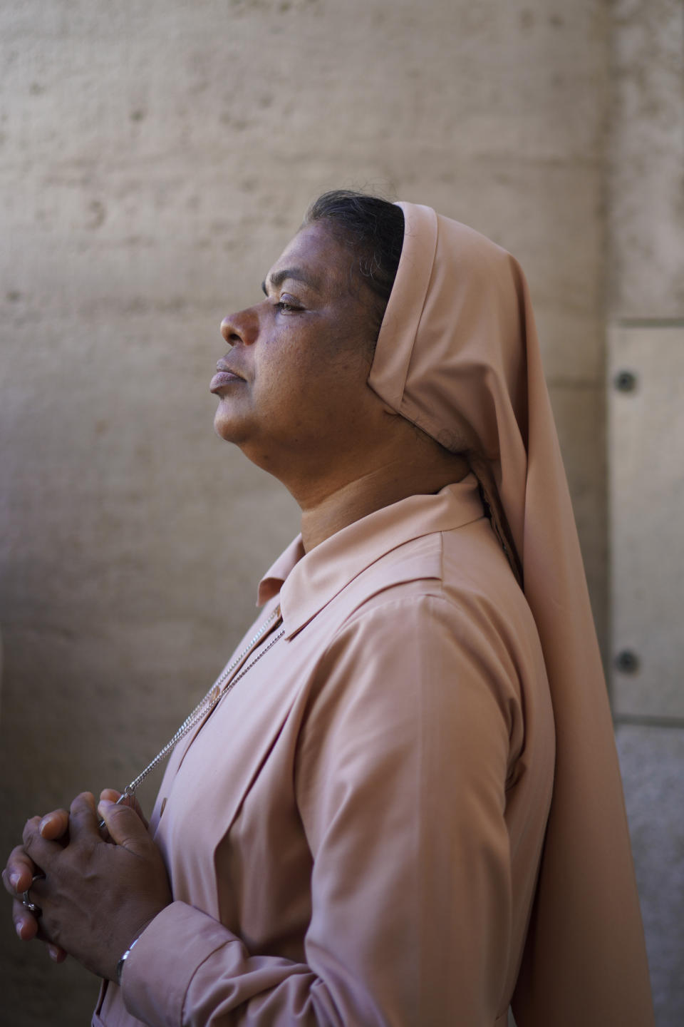 A nun prays as Pope Francis celebrates Mass on the occasion of the Migrant and Refugee World Day, in St. Peter's Square, at the Vatican, Sunday, Sept. 29, 2019. (AP Photo/Andrew Medichini)