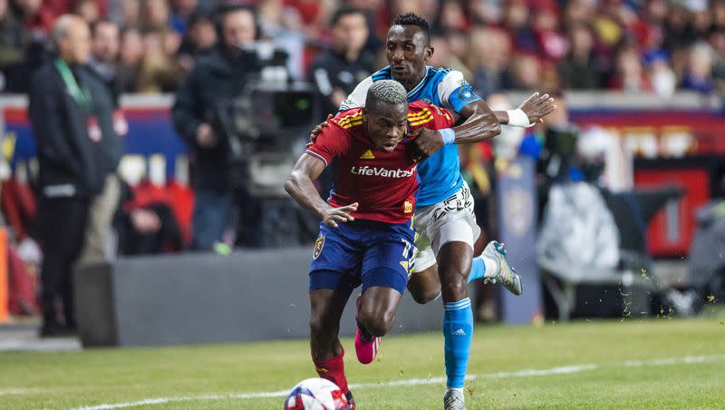 Real Salt Lake forward Carlos Andrés Gómez (11) is pulled by Charlotte FC defender Jaylin Lindsey (24) during an MLS match between Real Salt Lake and Charlotte FC at America First Field in Sandy on April 8, 2023.
