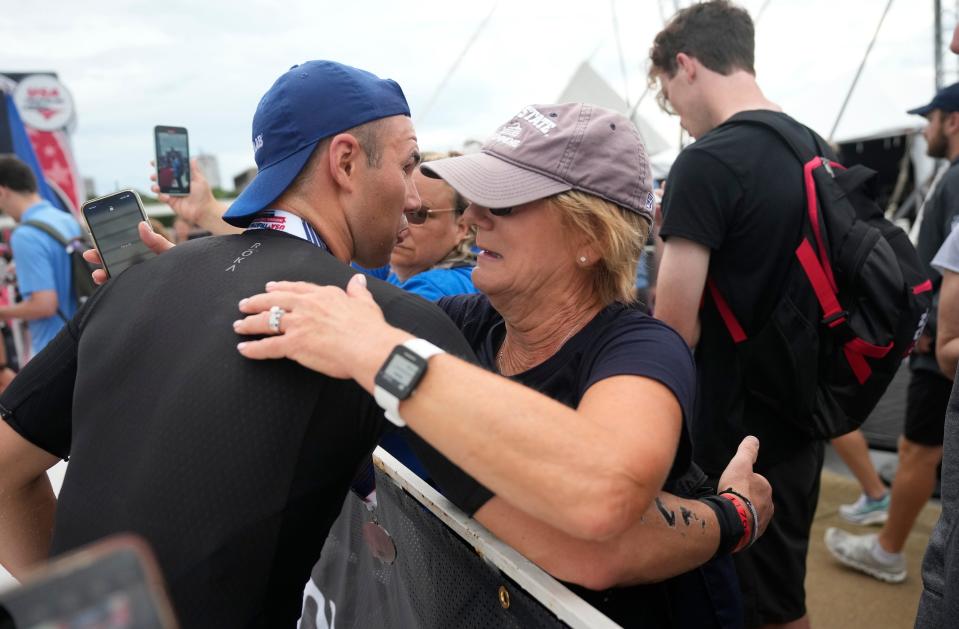 Matt Guenter, from Boulder, Colorado, hugs his mother, Barbara, after his first-place finish Sunday in the USA Triathlon Age Group National Championships sprint in Milwaukee.