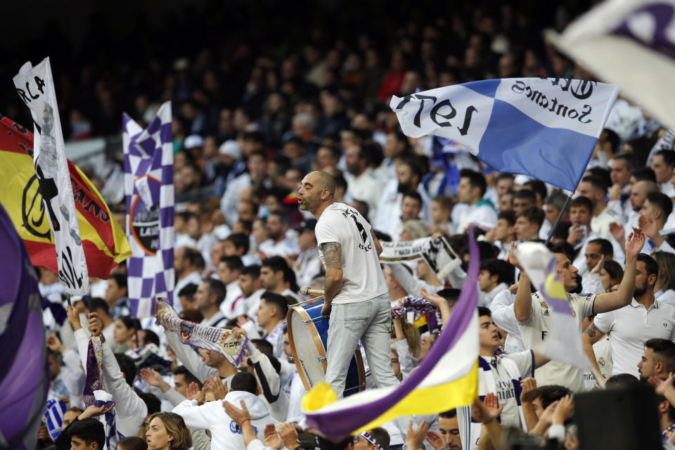 Real Madrid fans cheer during a round of 32, 2nd leg, Spanish Copa del Rey soccer match between Real Madrid and Melilla at the Santiago Bernabeu stadium in Madrid, Spain, Thursday, Dec. 6, 2018. (AP Photo/Paul White)
