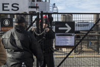 <p>A United States Park Police officer, center, locks a gate leading to a Statue of Liberty ferry, Saturday, Jan. 20, 2018, in New York. The National Park Service announced that the Statue of Liberty and Ellis Island would be closed Saturday “due to a lapse in appropriations.” Late Friday, the Senate failed to approve legislation to keep the government from shutting down after the midnight deadline. (Photo: Mary Altaffer/AP) </p>