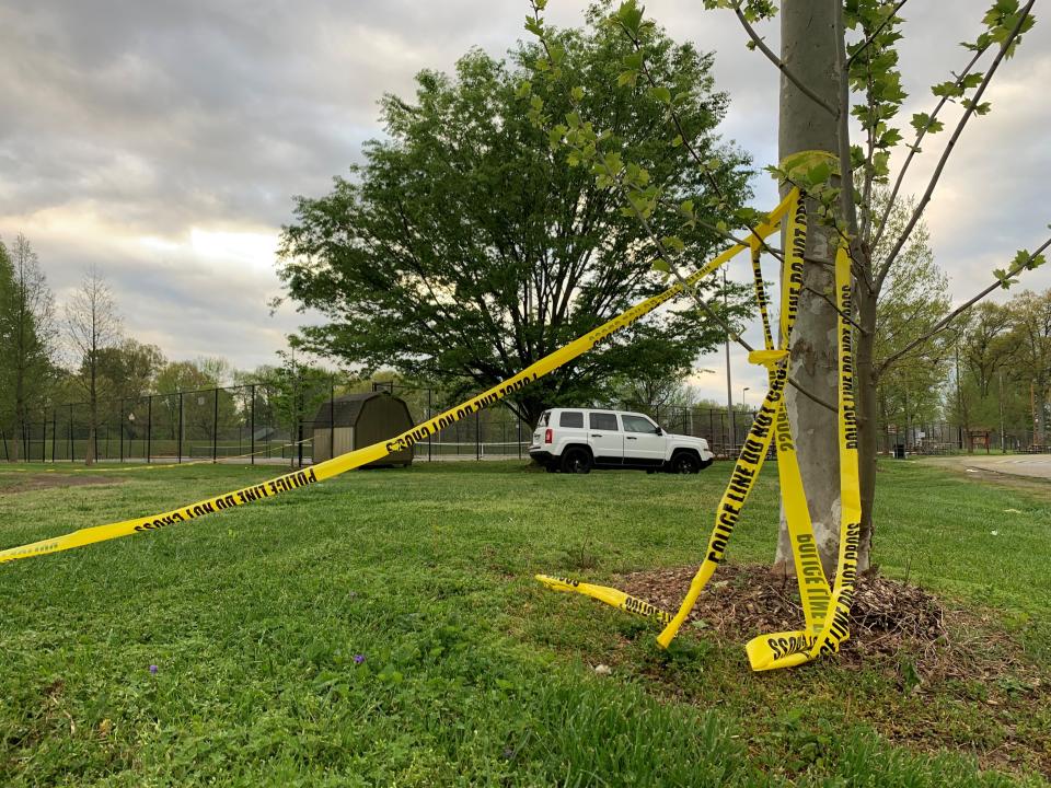The remnants of police tape are visible Sunday morning, April, 16, 2023, near the tennis courts at Chickasaw Park following a shooting late Saturday night, April 15, that killed two and injured four others.