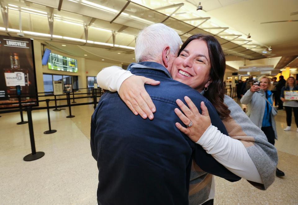 Nancy Galloway, 53, right, embraced her dad Alan Freedman, 82, as he arrived at the Louisville Muhammad Ali International Airport in Louisville, Ky. on Nov. 15, 2022.  Galloway used DNA testing to identify Freedman as her father and located him in Australia.