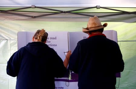 Farmer Darrell Peirpoint votes next to a local resident in the remote voting station in the western New South Wales outback town of Enngonia, Australia, June 22, 2016. REUTERS/David Gray