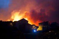 <p>A forest fire rages on a hillside above the village of Ortale in Corsica, France, July 24, 2017. Hundreds of firefighters are battling blazes fanned by high winds in more than a dozen zones in the Riviera region of southern France. (Raphael Poletti/AP) </p>