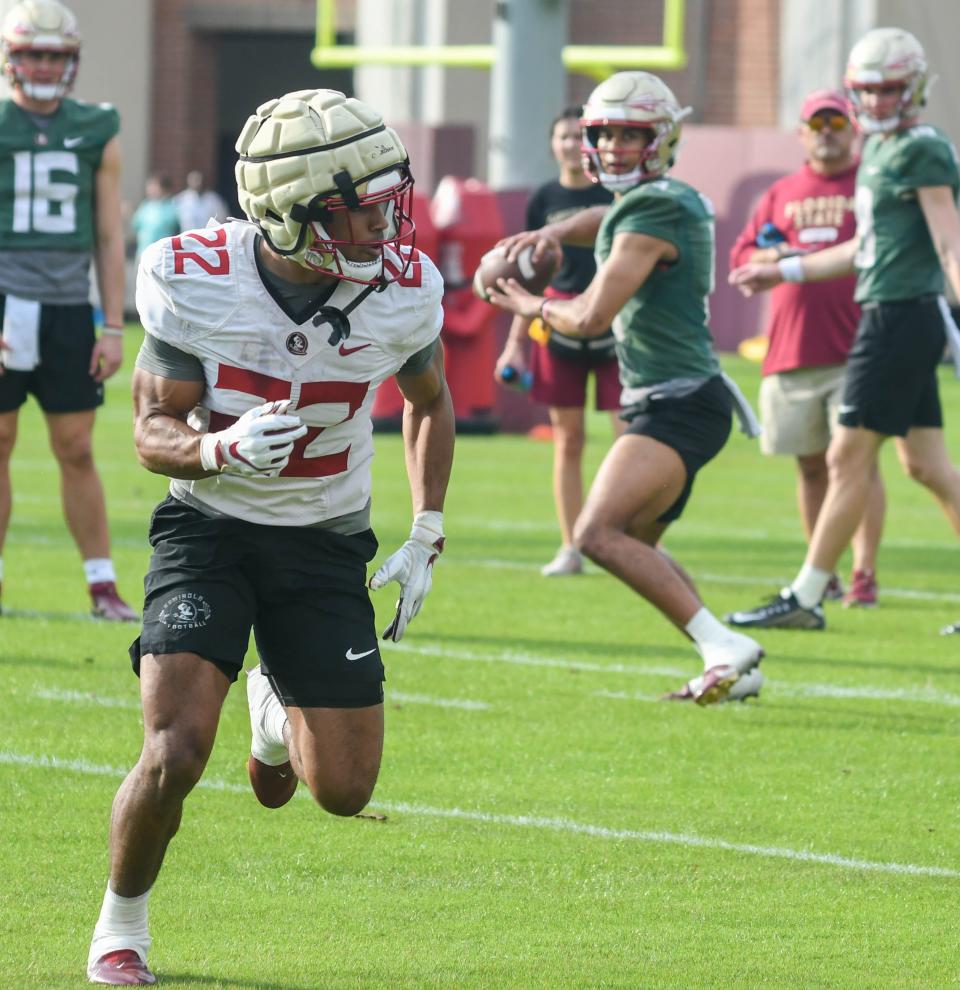 Florida State quarterback Jordan Travis (right) looks to pass the ball to running back CJ Campbell during a drill Monday, March 6, 2023, at the first FSU spring football practice.