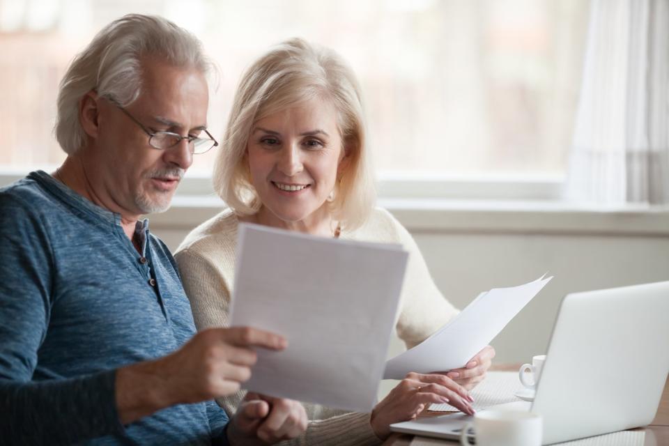 Couple studying document together.