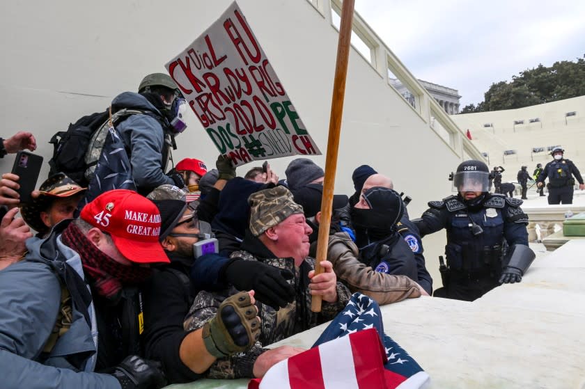 Trump supporters clash with police and security forces as they invade the Inauguration platform of the US Capitol in Washington, DC on January 6, 2021. - Demonstrators breeched security and entered the Capitol as Congress debated the a 2020 presidential election Electoral Vote Certification. (Photo by ROBERTO SCHMIDT / AFP) (Photo by ROBERTO SCHMIDT/AFP via Getty Images)