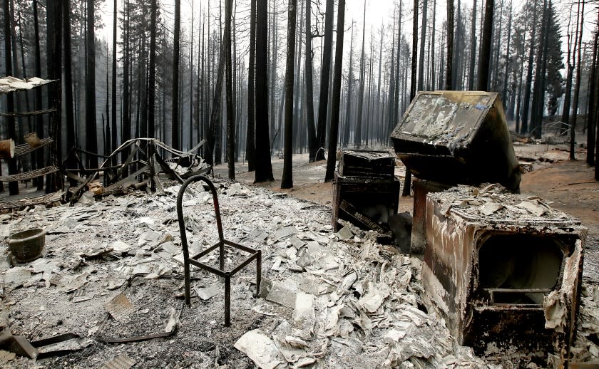 GRIZZLY FLATS, CALIF. - AUG. 18, 2021. A chairr stands in a charred home in Grizzly Flats, which was destroyed by the Caldor Fire on Wednesday, Aug. 18, 2021. (Luis Sinco / Los Angeles Times)