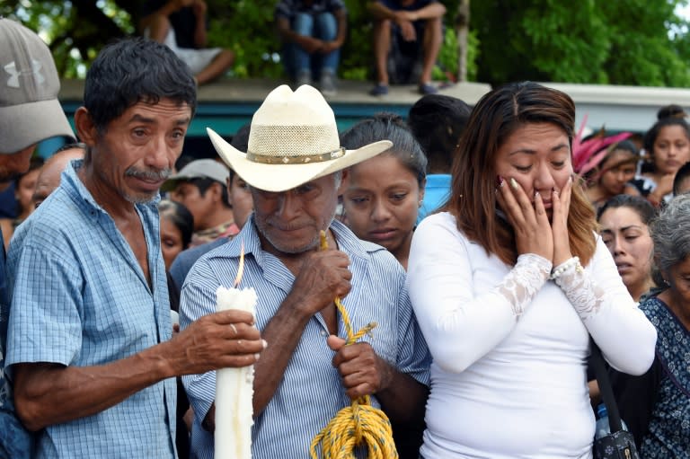 Relatives and friends of thirteen people killed when a military helicopter fell on a van in Santiago Jamiltepec, Mexico, attend the funeral of one of the victims