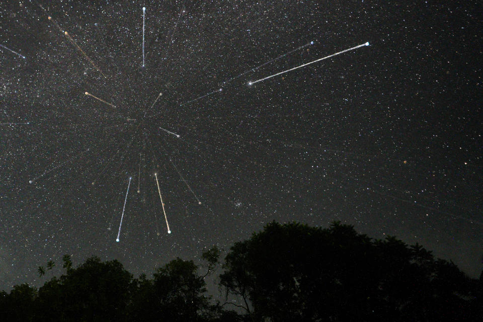 streaks of light crisscross the night sky