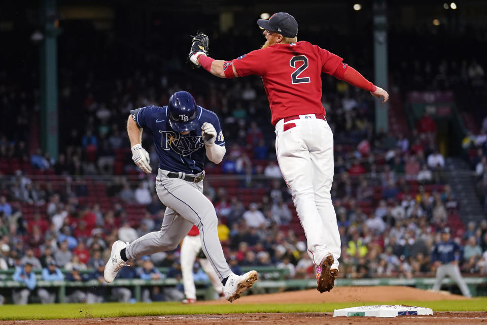 Tampa Bay Rays' Taylor Walls, left, ducks under the tag by Boston Red Sox first baseman Justin Turner (2) during the second inning of a baseball game at Fenway Park, Wednesday, Sept. 27, 2023, in Boston. (AP Photo/Charles Krupa)