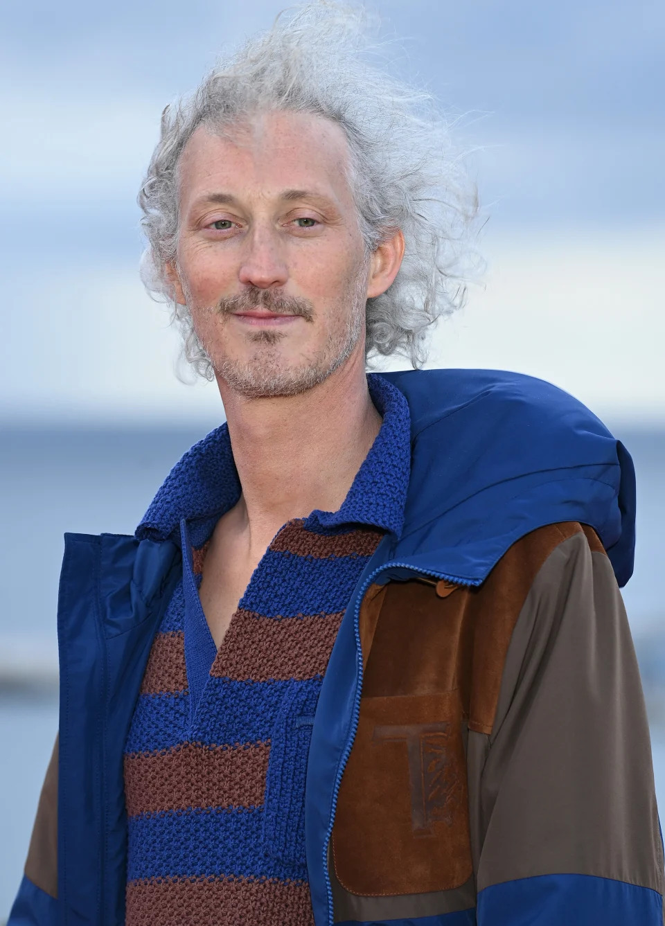 Bruno Gouery in a striped sweater and a matching jacket in Cannes, France