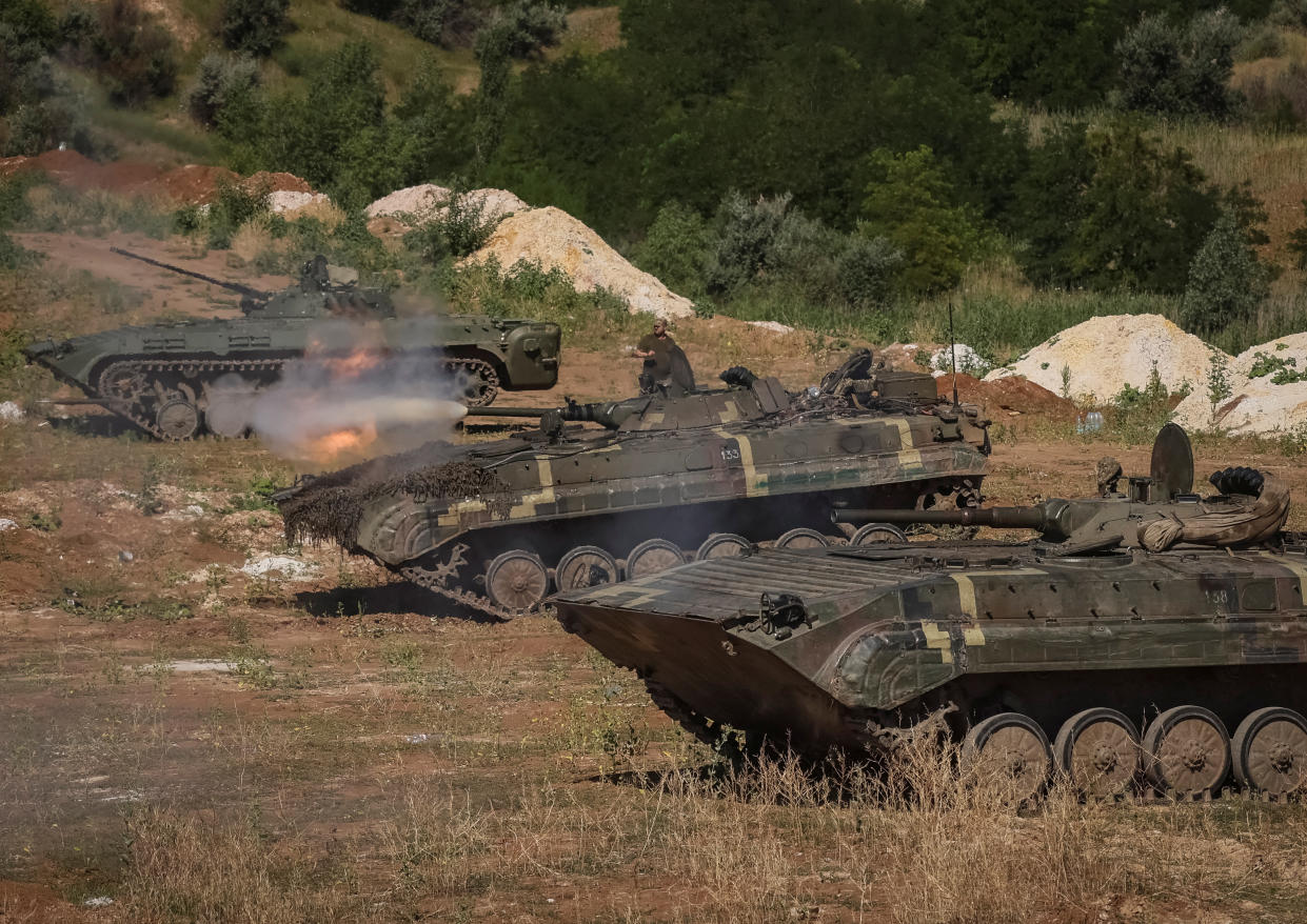 Ukrainian servicemen fire from a BMP-1 infantry fighting vehicle during a training exercise.