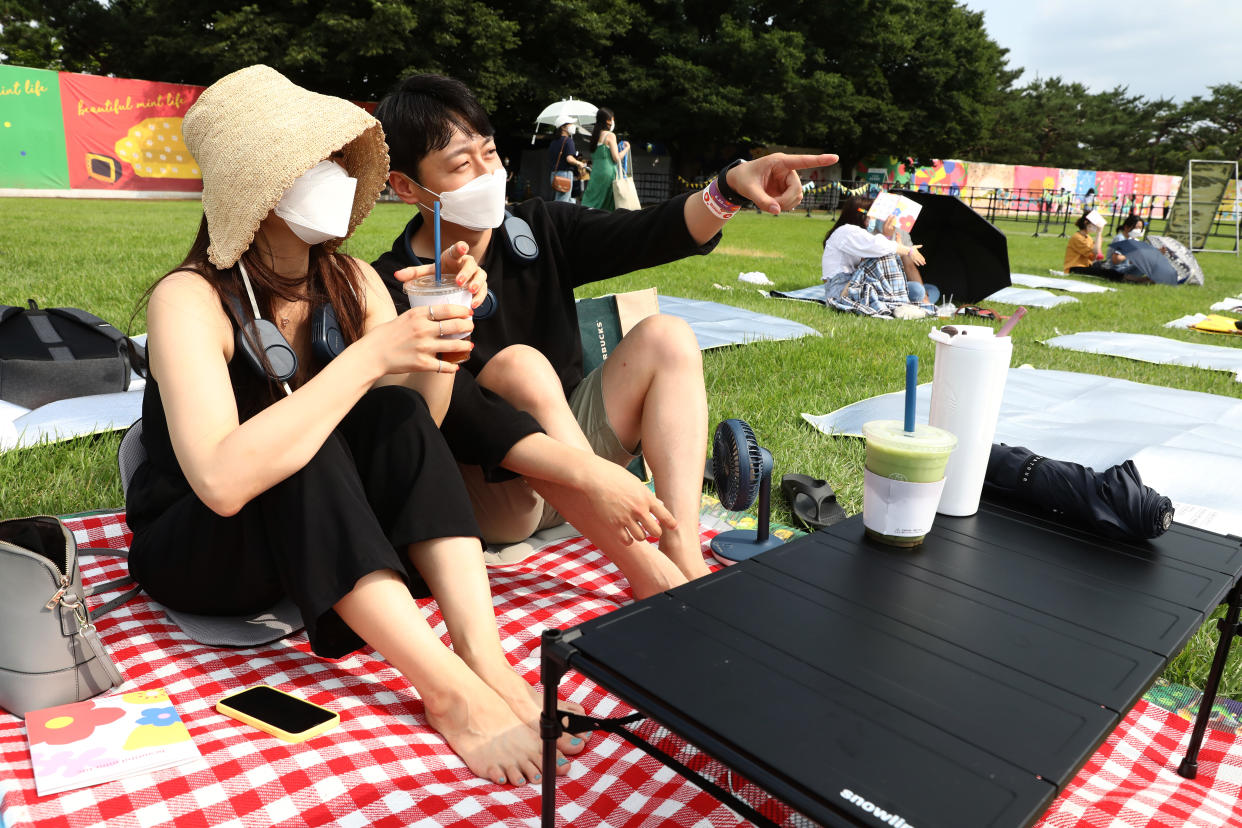 Festivalgoers attend a music festival after taking a rapid self-test kit at Olympic park in Seoul, South Korea